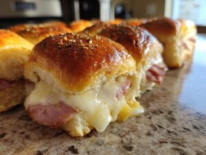 Close-up of a delicious ham and cheese slider with melted cheese oozing out.