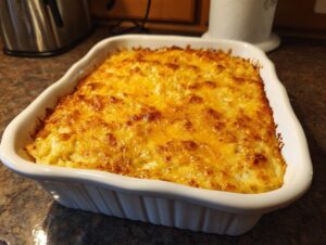 A golden-brown, bubbly hashbrown casserole fresh from the oven, topped with melted cheese.