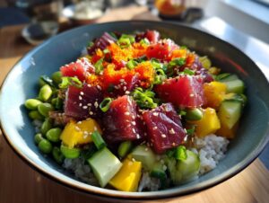 A vibrant Tuna Poke Bowl filled with fresh tuna cubes, edamame, mango, cucumber, and tobiko on a bed of rice.