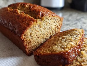 Close-up of a moist and easy banana bread loaf, with two slices cut and ready to serve.