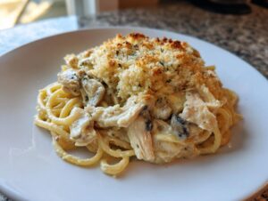 A serving of creamy Turkey Tetrazzini pasta mixed with shredded turkey and mushrooms, topped with golden breadcrumbs.
