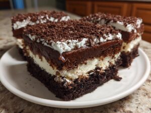 Three rich slices of brownie refrigerator cake featuring dark chocolate base, cream layer, and chocolate topping with shavings.