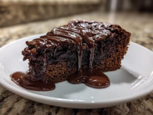 A decadent slice of hot fudge brownie bread topped with rich, glossy hot fudge sauce.