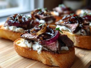 Close-up of a perfectly prepared steak crostini topped with creamy cheese and caramelized red onions.